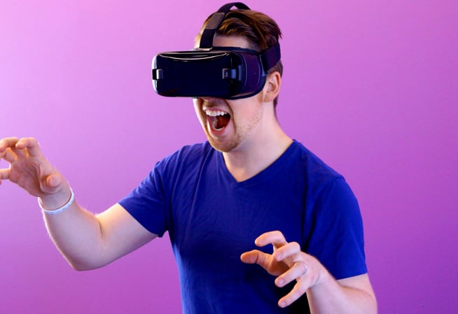 Picture of a man playing a game with a VR headset